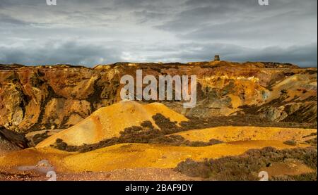 View of Parys Mountain copper mine in Anglesey showing bright orange, red and yellow colours Stock Photo