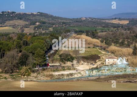 The beautiful natural thermal springs of Saturnia Cascate del Mulino, Grosseto, Tuscany, Italy, next to a typical stone cottage Stock Photo