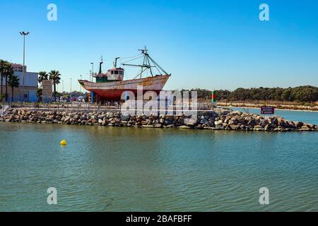 Fishing boat on dry land, Marina De Las Dunas harbour, Guadamar del Segura, Costa Blanca, Spain Stock Photo