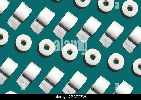 Pattern of rolls of many white toilet paper on deep mint background. Nowel Corona virus infection background. Covid-19. Pandemic panic concept. Stock Photo