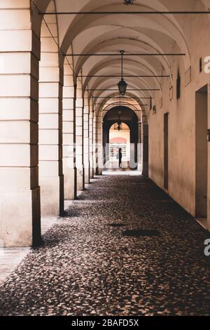 Vertical shot of a hallway with concrete columns Stock Photo