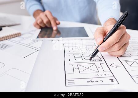Close-up of unrecognizable UI engineer using digital tablet while working on app planner design for gadgets Stock Photo