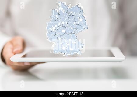 Illustration of the map of Germany connected with dots on top of the phone in the hands of a man Stock Photo