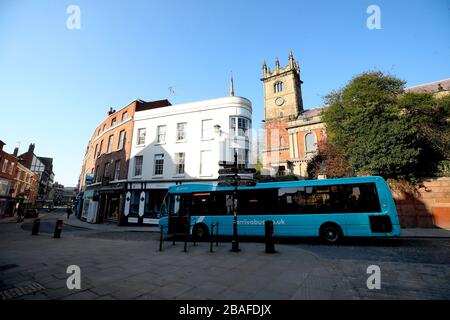 A local bus drives down nearly empty streets near The Abbey in Shrewsbury as the UK continues in lockdown to help curb the spread of the coronavirus. Stock Photo