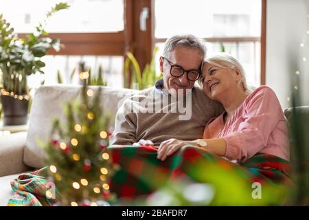 Senior couple in the living room together during Christmas Stock Photo