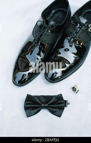 Groom accessories. Shoes, cufflinks and bow ties. On blue background. Stock Photo