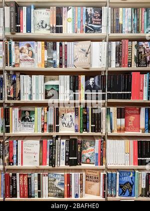 Book shop. Full frame image of classic and modern fiction paperback books and novels on the shelves of a book store. Stock Photo