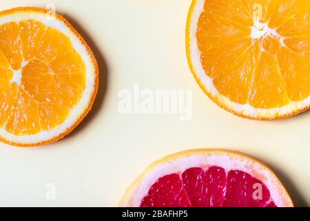 Pattern of citrus orange and grapefruit slices on light yellow background. Top view. Minimal design. Stock Photo