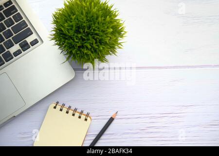 top view of laptop, notepad and pen on table with copy space. Stock Photo