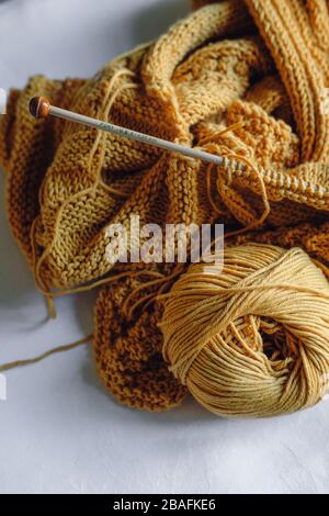 Yellow knitting yarn ball with needles Stock Photo