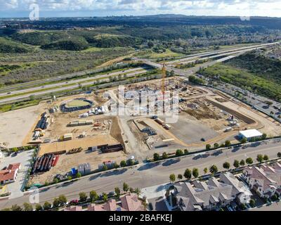 Aerial view of investors and contractors on construction site with crane. New construction site with crane and building materials. San Diego, California, USA. March, 26th, 2020  Stock Photo