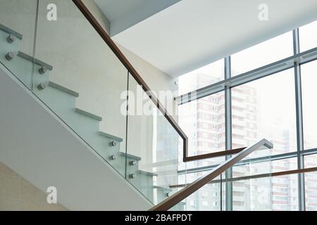 Part of staircase with railings and large window inside new contemporary business center or office building with many floors Stock Photo