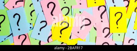 Too Many Questions. Pile of colorful paper notes with question marks. Closeup. Stock Photo