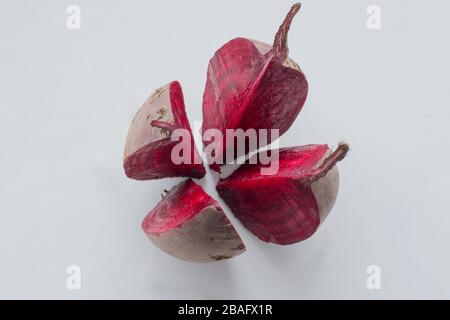 Cut into four pieces red beet isolated on white background, top view Stock Photo