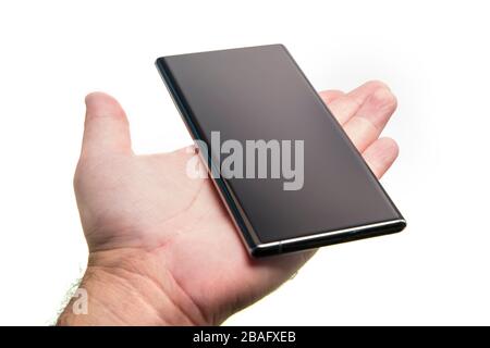 Hand held generic mobile phone over white, black smartphone Stock Photo
