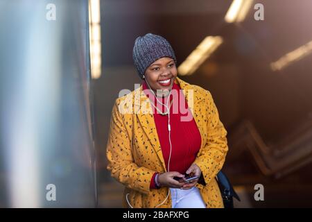 Young woman with smartphone in an urban city area Stock Photo