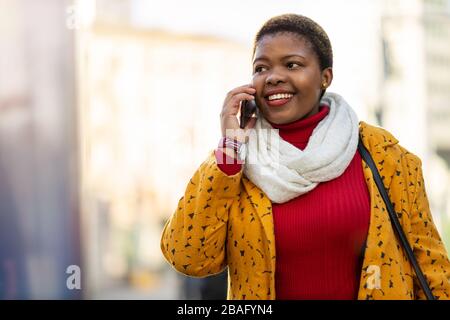 Young woman with smartphone in an urban city area Stock Photo
