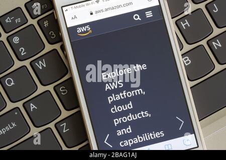 Amazon Web Services web page seen on a smartphone. AWS provides on-demand cloud computing platforms and APIs to individuals, companies and governments. Stock Photo