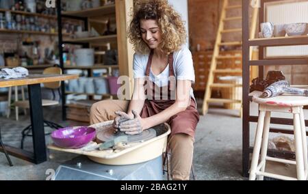 Portrait of woman pottery artist in art studio Stock Photo