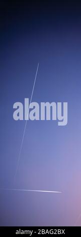 Blue sky with passenger jet aircraft vapour trails. Stock Photo