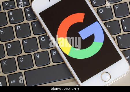 Google icon is seen on a smartphone. Stock Photo