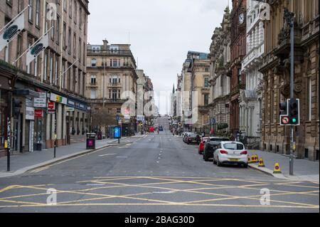 Glasgow, UK. 27th Mar, 2020. Pictured: Views of Glasgow City Centre showing empty streets, shops closed and empty railway stations during what would normally be a busy street scene with shoppers and people working within the city. The Coronavirus Pandemic has forced the UK Government to order a shut down of all the UK major cities and make people stay at home. Credit: Colin Fisher/Alamy Live News Stock Photo