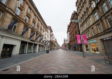 Glasgow, UK. 27th Mar, 2020. Pictured: Buchanan Street - Glasgows style mile, which is now like a ghost town. Views of Glasgow City Centre showing empty streets, shops closed and empty railway stations during what would normally be a busy street scene with shoppers and people working within the city. The Coronavirus Pandemic has forced the UK Government to order a shut down of all the UK major cities and make people stay at home. Credit: Colin Fisher/Alamy Live News Stock Photo