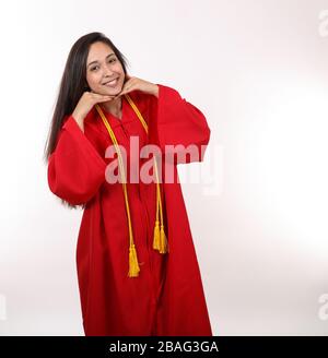 A pretty graduating student poses for the camera. Stock Photo