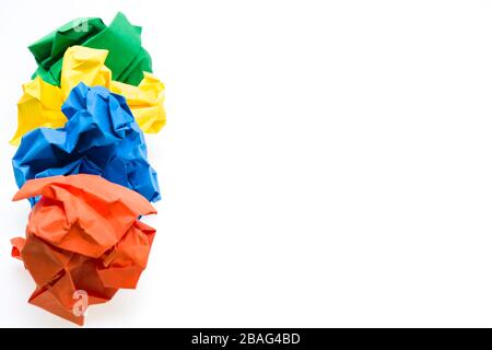 Colored crumpled paper ball in a row, focus on the blue one Stock Photo