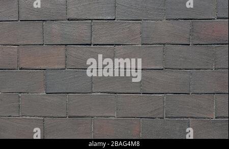 The texture of the brown paving stones used to pave the road. Background Stock Photo