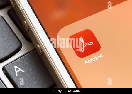Acrobat Reader mobile app icon seen on a smartphone. The application enables users to view, sign, and comment on PDF documents from mobile devices. Stock Photo