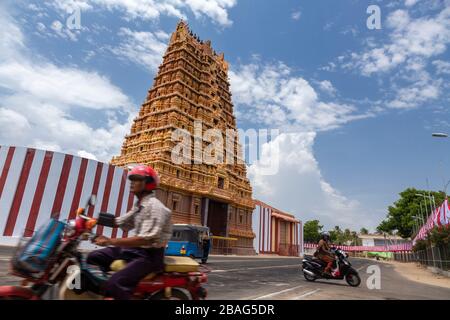 Man on a motorcycle in front of a Hindu temple in Jaffna, Sri Lanka Stock Photo