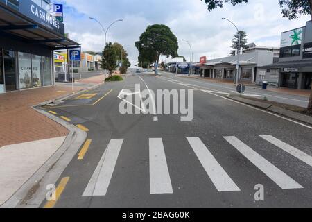Tauranga New Zealand - March 27 2020; Empty city streets leave an eerie feeling with one distant car during global pandemic of the corona-virus.