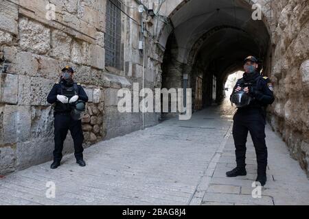 Israeli police officers wearing protective mask stand guard at Via Dolorosa street in the old city East Jerusalem during the outbreak of the coronavirus disease (COVID-19) in Israel Stock Photo