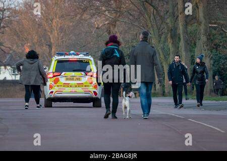 London, UK. 27th March, 2020. Coronavirus: Police Park Patrols. A police car patrols around Royal Greenpark Park dispersing, via megaphone, any groups larger than two, those not visibly exercising and enforcing the current coronavirus gathering restrictions. Police have been granted extra powers to enforce the lockdown - including issuing on the spot fines. Credit: Guy Corbishley/Alamy Live News Stock Photo