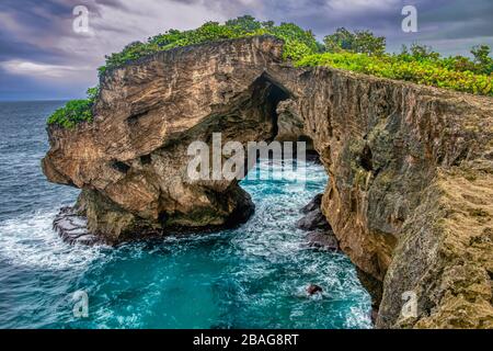 Small waves crash against the beautiful cliffs of Cueva del Indio on the island of Puerto Rico. Stock Photo