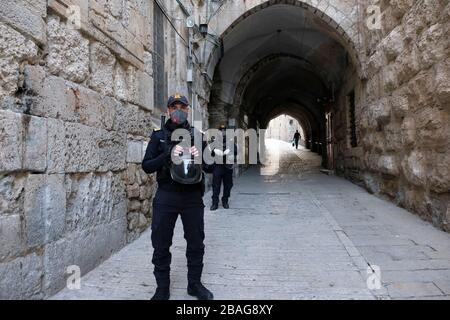 Israeli policemen wearing protective mask stand guard at Via Dolorosa street in the old city East Jerusalem during the outbreak of the coronavirus disease (COVID-19) in Israel Stock Photo