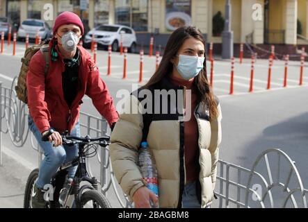 People wearing protective face masks as a preventive measure against the COVID-19 coronavirus in Kiev.The Ukrainian Government introduced a national emergency for 30 days and extends the quarantine against the spread the COVID-19 coronavirus in Ukraine till 24 April 2020. As of 10:00 am on 27 March 2020 there were 218 laboratory confirmed COVID-19 cases in Ukraine, of which 5 were lethal and 4 were recovering. During the day, 62 new cases were recorded in Ukraine. Stock Photo