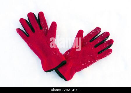 red gloves on snow surface Stock Photo