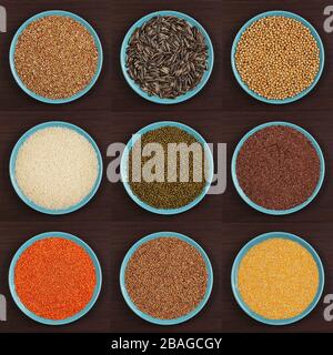 Different types of groats in dish on a brown background. Various groats, cereals. Healthy nutrition food Stock Photo