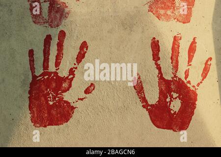 close up of colored hand print on grey concrete background Stock Photo