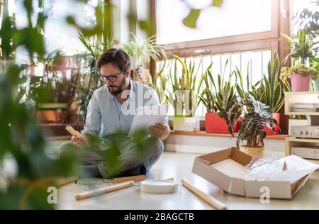 Man working on a D.I.Y project at home Stock Photo
