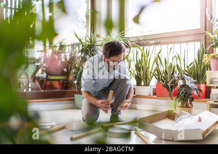 Man working on a D.I.Y project at home Stock Photo