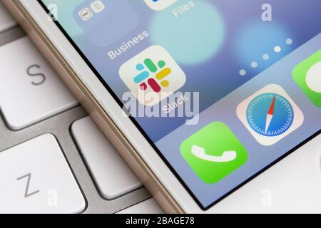 Slack mobile app icon is seen on a smartphone. Slack is a B2B software, workplace messenger, team communication tool or platform. Stock Photo