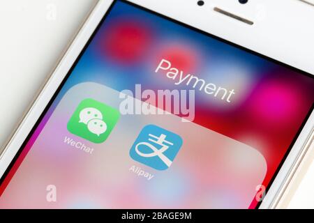 WeChat and Alipay mobile app icons are seen on a smartphone. Stock Photo