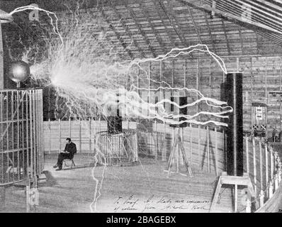 NIKOLA TESLA (1856-1943) Serbian-American inventor and electrical engineer in his laboratory in Colorado Springs about 1899. The image is a double exposure. Photographer Dickenson Alley first recorded the millions of volts created by Tesla's 'magnifying transmitter' then exposed the same plate with Tesla seated.