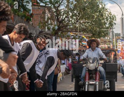 Dance group at comuna 13, Medellin interrumped by a motorcycle Stock Photo
