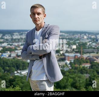 portrait of young handsome serious businessman on city background Stock Photo