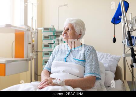 Senior patient in hospital bed Stock Photo