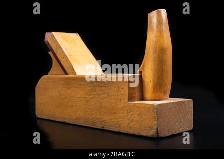 Carpentry planer for leveling wood. Carpentry accessories in the workshop. Dark background. Stock Photo